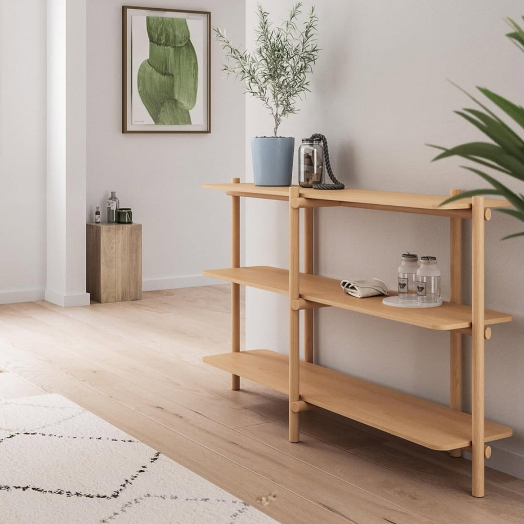 Wooden shelf with decorative items in a room with a rug and plant COZONI