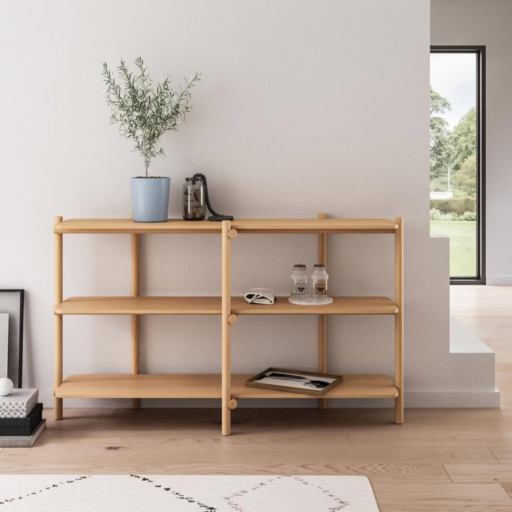 Wooden shelf with decorative items against a white wall COZONI