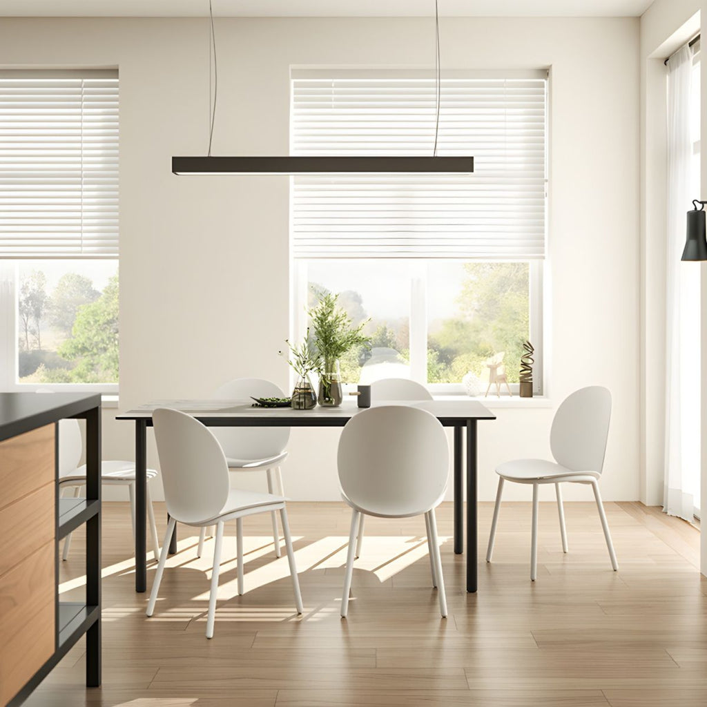Modern dining room with a black table and white chairs, large windows, and a light wood floor. COZONI