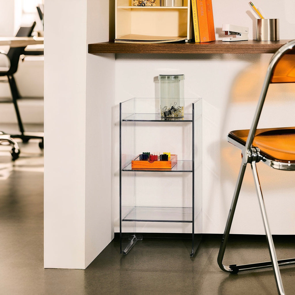 Glass display cabinet with books and decorative items in an office setting