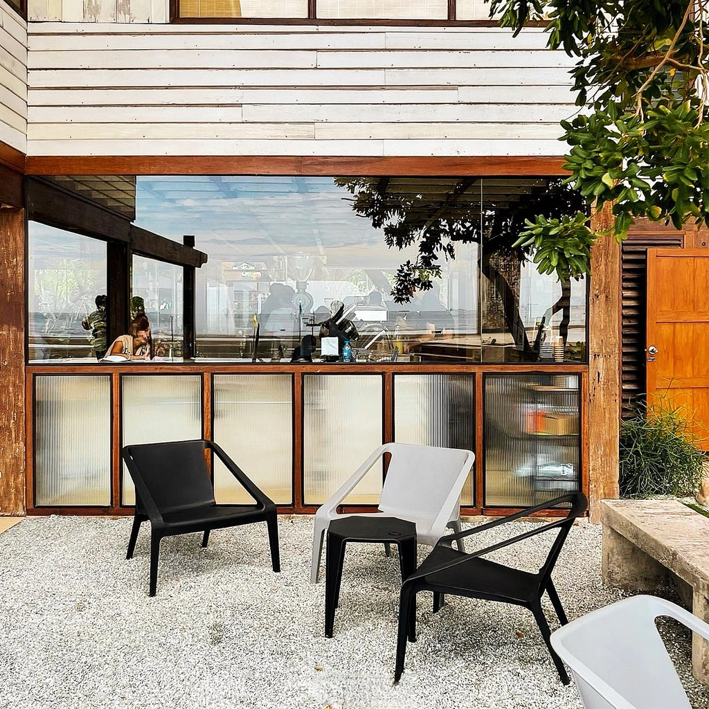 Modern outdoor kitchen with chairs and a view of the city.