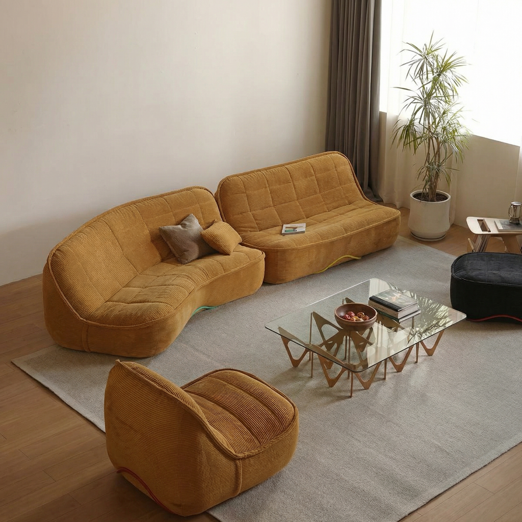 Modern living room with a yellow sectional sofa, glass coffee table, and decorative items.